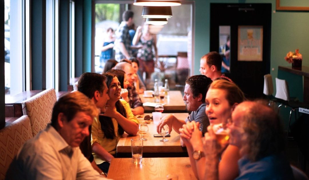 Guests enjoying a meal at a busy restaurant.