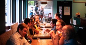 Guests enjoying a meal at a busy restaurant.